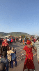 Crowd gathers in traditional dress on Lokoja street