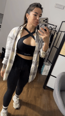 Woman takes selfie video making peace sign indoors