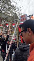 Young man performs pull-ups on outdoor bar in Amsterdam