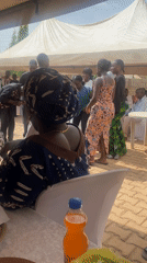Community celebration with dancing under tent in Kura, Nigeria
