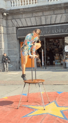 Acrobats and a macaw draw attention on a Santiago street