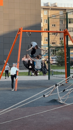 Children play on swings and equipment at Ufa playground