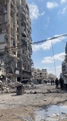 Post-damage scene with debris, flooded streets, and ladder work