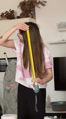 Woman measures hair with tape measure in Kragujevac