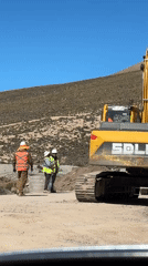 Construction crews operate heavy machinery in Putre, Chile worksite