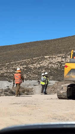 Construction crews operate heavy machinery in Putre, Chile worksite