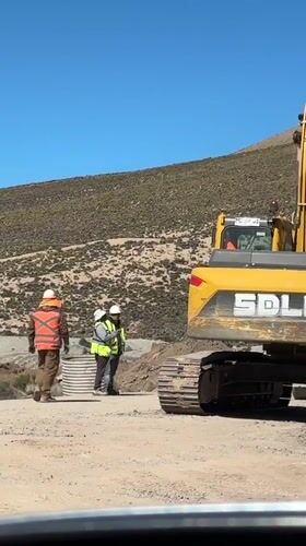 Construction crews operate heavy machinery in Putre, Chile worksite