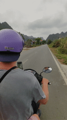 Moped rider with phone mount travels Hải Phòng road