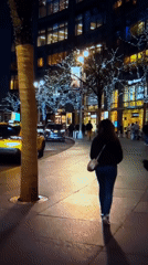 City street at night: taxis, lit buildings, and a Jazz sign
