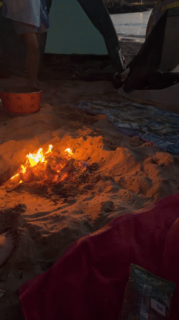 Campfire and tents on a Bulgarian beach at dusk