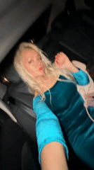 Late-night car ride through Moscow, teal dress, red light