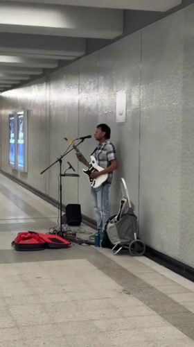 Electric guitar busking on a Montreal pedestrian walkway