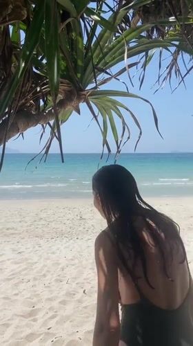 Beach day on a calm Vietnamese coastline, green swimsuit and selfies