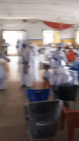 Religious ceremony with white-robed congregation in Lokoja hall