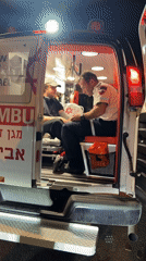Two men observed in open ambulance at night in Tel-Aviv