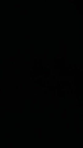 The media file is a video showing a dark, night scene in Auk, Kyrgyzstan. A sliver of a crescent moon is visible in the upper left quadrant of the frame. The rest of the frame is black, suggesting it was filmed at night, possibly with a camera that struggled with low-light conditions. There is no discernible activity or event taking place. No people, objects, or specific location cues are visible beyond the general context of Auk, Kyrgyzstan. The absence of light makes it impossible to determine the weather or any specific emotions conveyed. There is no visible text in the media file.