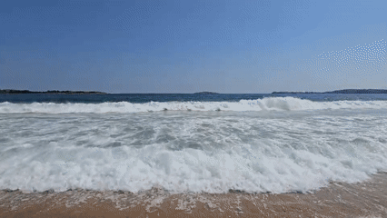 Calm beach morning with island on the horizon