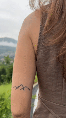 Woman walks mountain road amid scenic Bulgarian countryside