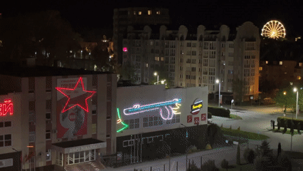 Building displays cycling military neon projections in Zelenogradsk