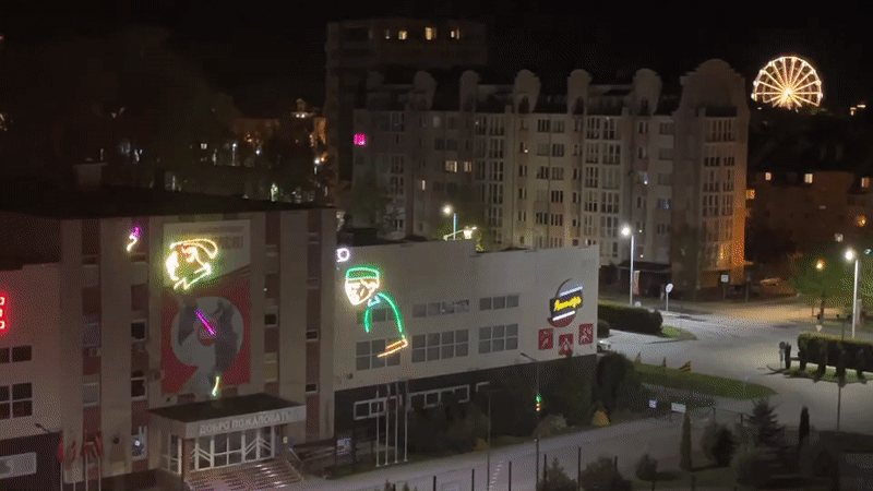 Building displays cycling military neon projections in Zelenogradsk