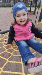 Toddler plays at Timmolovo playground during overcast afternoon