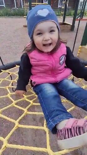Toddler plays at Timmolovo playground during overcast afternoon