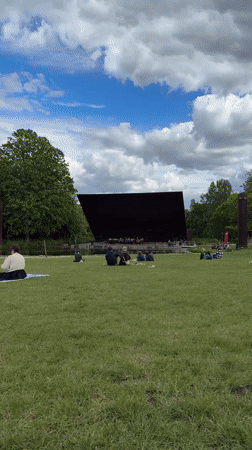 Brass band in red uniforms performs outdoor concert in London