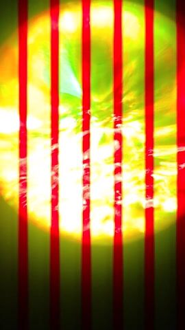 The video displays an abstract, dynamic visual centered around a large, glowing circular shape against a dark, black background.

At the beginning (0:00), the circle is intensely bright, predominantly yellow and green with swirling white and orange highlights in its core, suggesting an energetic, almost plasma-like substance. Red horizontal lines are overlaid across the entire frame, including the glowing circle, creating a scanline or glitch effect.

As the video progresses slightly (around 0:01-0:02), the color scheme shifts. The horizontal lines transition from red to a vibrant green, which then turns into a more muted green with yellow edges. Simultaneously, the dominant color within the glowing circle changes from yellow/orange to a bright, almost neon green. The central, brightest part of the circle becomes more white and light blue, still maintaining a swirling, energetic texture. The green horizontal lines now cleanly cut across this green and white/blue circle.

By the end of the clip, the glowing circle is largely a luminous green with intense white-blue light radiating from its core, framed by the dark background and overlaid with the distinct green horizontal lines. The lines appear to be static in position but flicker slightly in intensity or color.

Accompanying the visuals is a continuous, deep, resonant sound. It's a low-frequency hum or drone, possibly with a subtle electronic or industrial quality, creating a sense of gravity or power that matches the intense visual energy. The sound persists throughout the duration of the video.