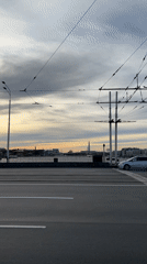 Bridge observer documents St. Petersburg river traffic, cityscape