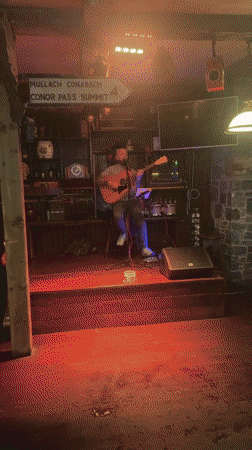 Acoustic guitarist performs during dinner service at Dublin pub