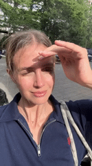 Woman in navy blue photographed outside in Tbilisi