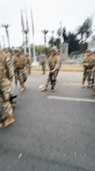 Armed soldiers in formation on a street in Arica, Chile