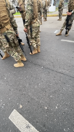Armed soldiers in formation on a street in Arica, Chile