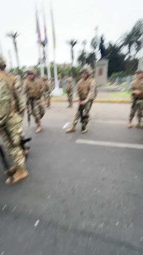 Armed soldiers in formation on a street in Arica, Chile