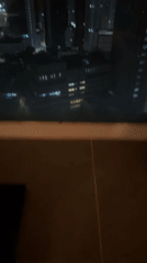 Night cityscape filmed through window in Hong Kong