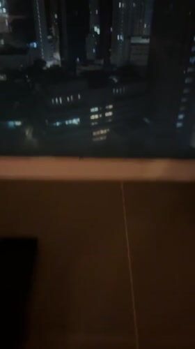 Night cityscape filmed through window in Hong Kong