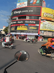 Nha Trang street life: motorbikes, a monk, and rail tracks