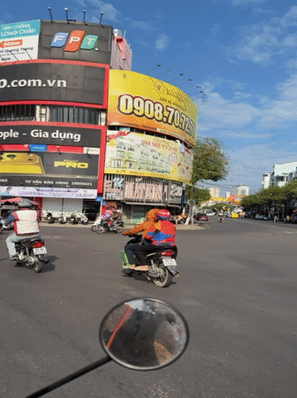 Nha Trang street life: motorbikes, a monk, and rail tracks