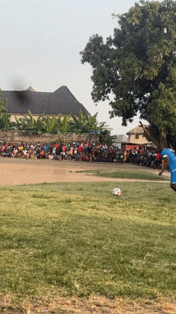Soccer match draws crowd on dirt field in Umuode