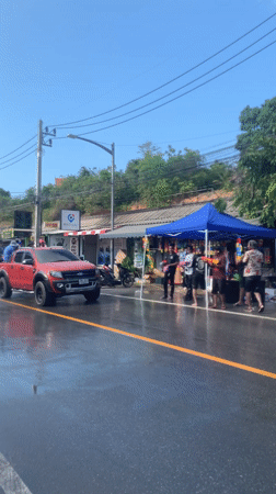 Water gun celebration observed alongside wet road in Thailand