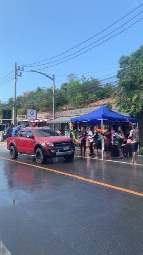 Water gun celebration observed alongside wet road in Thailand