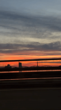 Riga skyline glows in orange and pink at sunset