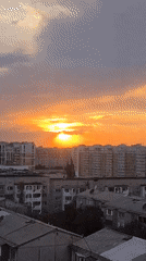 Almaty sunset breaks through storm clouds in vivid color