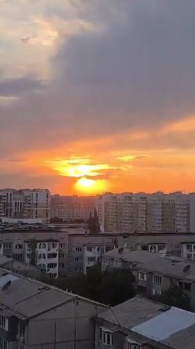 Almaty sunset breaks through storm clouds in vivid color