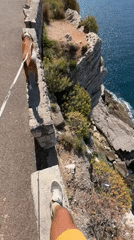 Dog walker spotted on cliff walkway in Montenegro