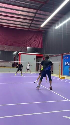 Doubles badminton match observed at Ko Samui sports facility