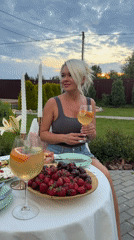 Casual outdoor dining spread with fresh fruit and white wine.
