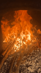 Indoor fire burns wooden materials in enclosed space