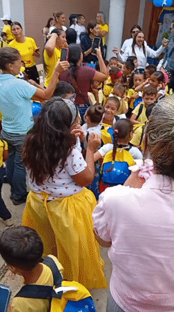 Venezuelan school children gather for outdoor ceremony with traditional dancing