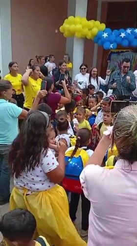 Venezuelan school children gather for outdoor ceremony with traditional dancing
